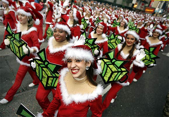 Elves walk through Times Square during a parade in New York