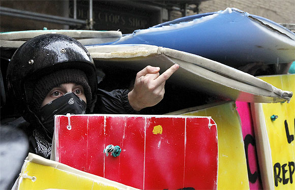 An Italian student gestures during a protest against various budget cuts the government has implemented in downtown Rome