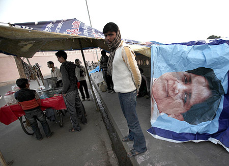 A tea stall vendor uses a banner of UP Chief Minister Mayawati to cover his roadside shop in Lucknow