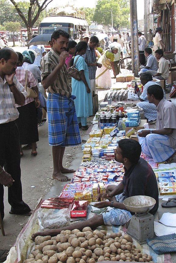 An ethnic Tamil street vendor sells his wares in Jaffna