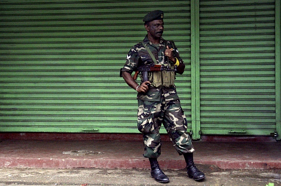 A Sri Lanka government soldier stands guard on a street in central Colombo