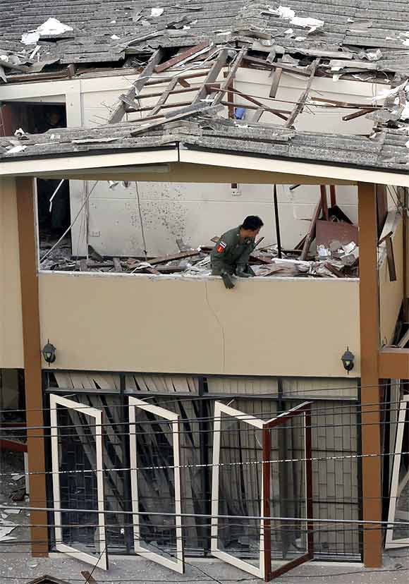 A police expert works at the site of an explosion in Ekamai area in central Bangkok