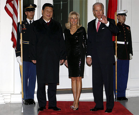 US Vice President Joe Biden and his wife Jill welcome Xi Jinping before a formal dinner at the vice president's residence in Washington