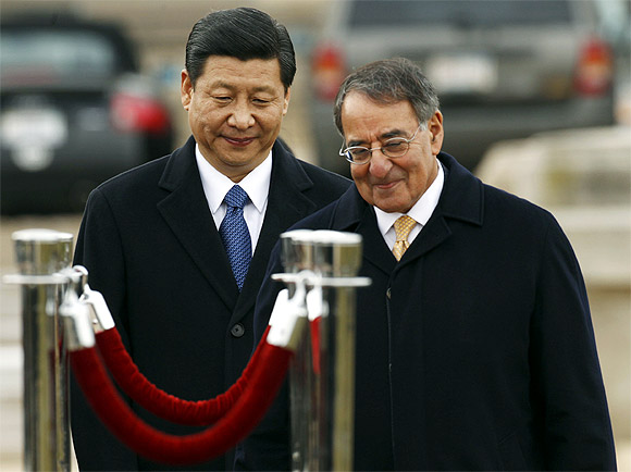 Xi Jinping and US Secretary of Defence Leon Panetta walk together at an arrival ceremony at the Pentagon in Washington February 14