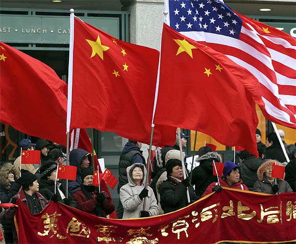 China supporters holding Chinese and US flags gather near the White House in Washington during the visit of Chinese Vice President Xi Jinping