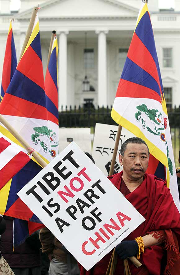 A Buddhist monk participates in a protest during the visit of Xi Jinping, in front of the White House in Washington