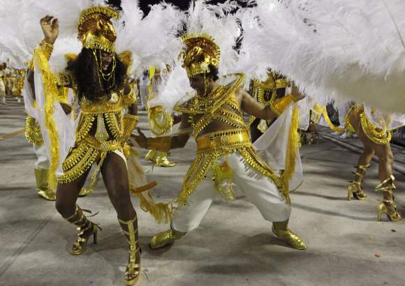 Revellers from the Porto da Pedra samba school parade on the first night of the annual Carnival parade in Rio de Janeiro's Sambadrome