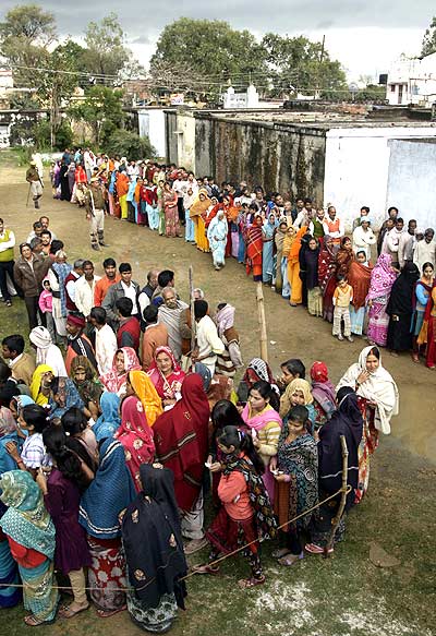 Voters outside a polling centre to cast their vote in Haraiya, UP