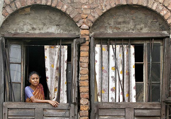 A woman watches a procession in Kolkata