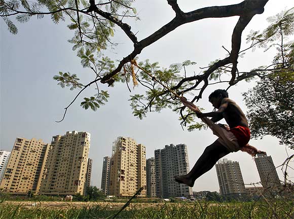 A boy plays in front of a residential estate in Kolkata