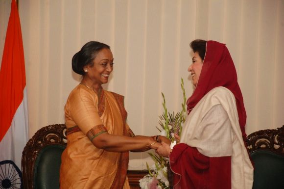 Meira Kumar greets Fehmida Mirza during a function at Pakistan national assembly