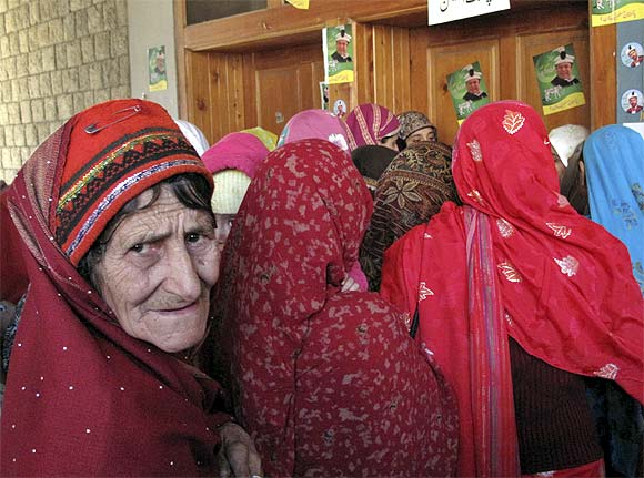 A woman stands in a queue to cast her vote during an election of the Legislative assembly for Northern Areas in Gilgit-Baltistan