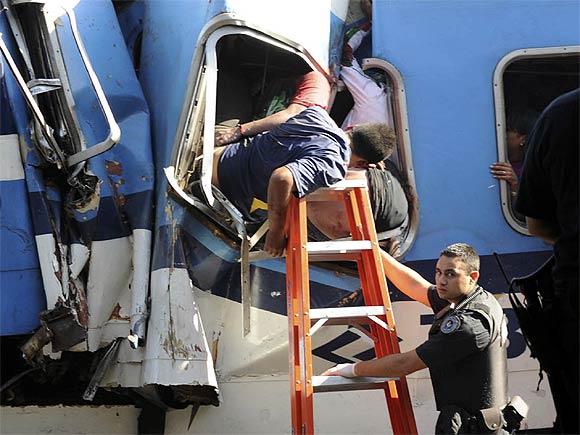 Trapped passengers from a commuter train that crashed into the Once train station at rush hour are seen in a coach in Buenos Aires