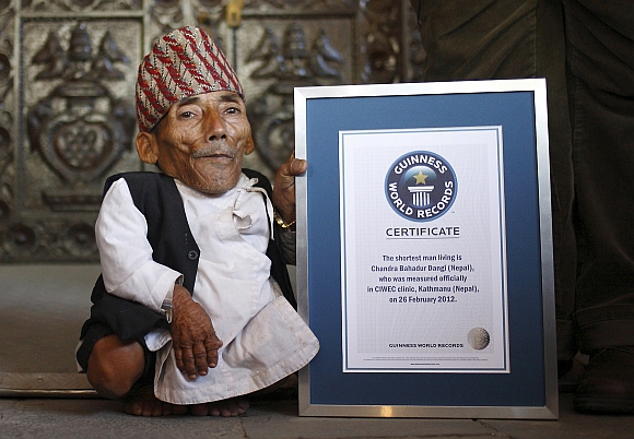 Chandra Bahadur Dangi poses for a picture with his certificate after being announced as the world's shortest man living, as well as shortest person ever measured by the Guinness World Records, in Kathmandu