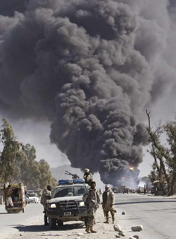 Smoke billows from a fuel tank supplying NATO troops, after it was set on fire by protesters during a demonstration in Jalalabad