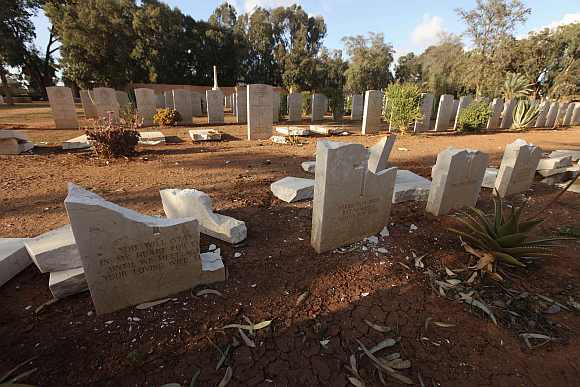 Gravestones are seen damaged by an Islamist group in protest at the burning of the Koran by U.S. soldiers in Afghanistan, in Benghazi Military Cemetery