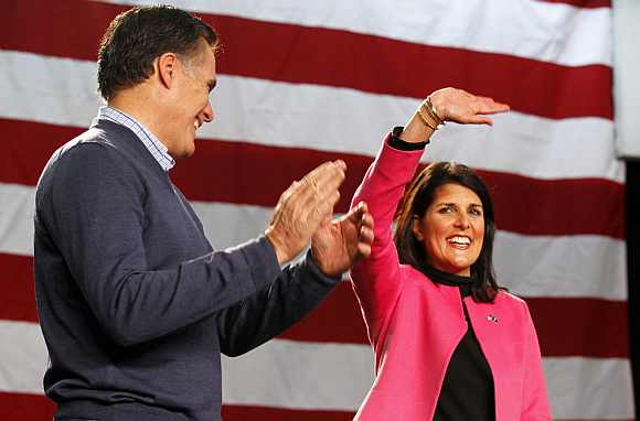 Republican presidential candidate and former Massachusetts Governor Mitt Romney applauds South Carolina Governor Nikki Haley as she is introduced to address a campaign rally at Pinkerton Academy in Derry, New Hampshire