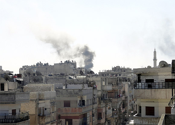 Smoke from shelling rises over the Khaldiyeh area in Homs city