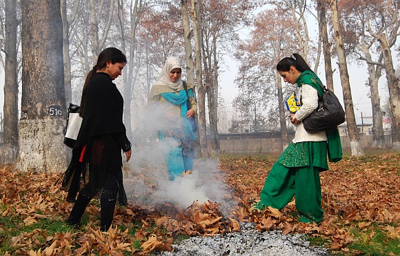 Local women warm themselves