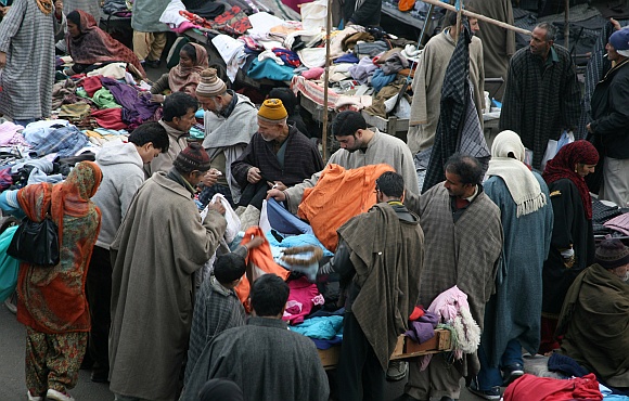 Locals buy warm clothes at a local market