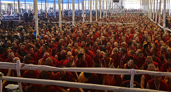 Buddhist monks listen to a teaching session being addressed by the Dalai Lama on the first day of the Kalachakra festival in Bodhgaya