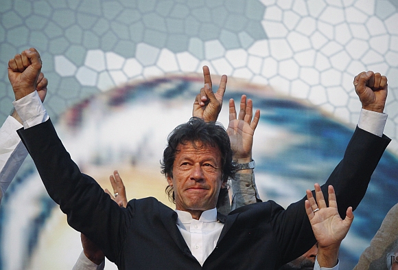 Imran Khan, Pakistani cricketer turned politician, gestures after arriving to lead the Pakistan Tehreek-e- Insaf (PTI) rally in Lahore.