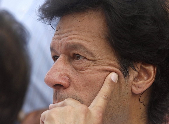 Khan is photographed on stage before leading a rally against drone attacks in Karachi.