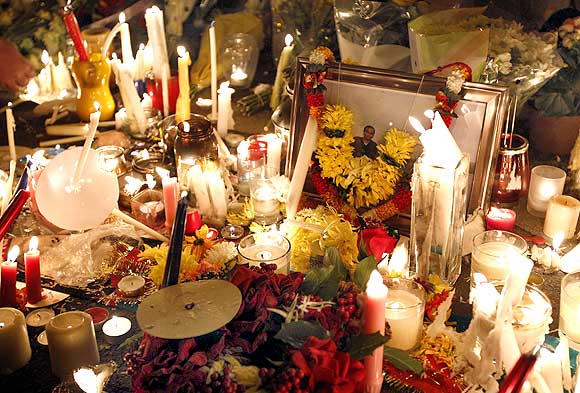Candles stand alongside a photograph of Anuj Bidve during a candle-light vigil at the spot where he was murdered in Salford, northern England