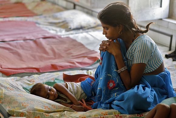 A mother looks at her malnourished child in a hospital in Bhopal