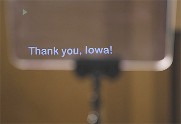 An onstage teleprompter screen reads 'Thank You, Iowa'