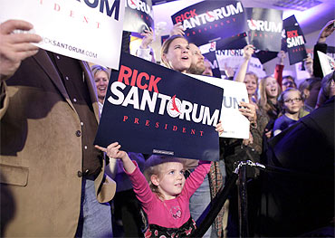 Supporters of Republican presidential candidate and former US Senator Rick Santorum cheer their candidate