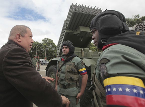 Venezuela's President Chavez talks to soldiers during a ceremony at the military academy in Caracas
