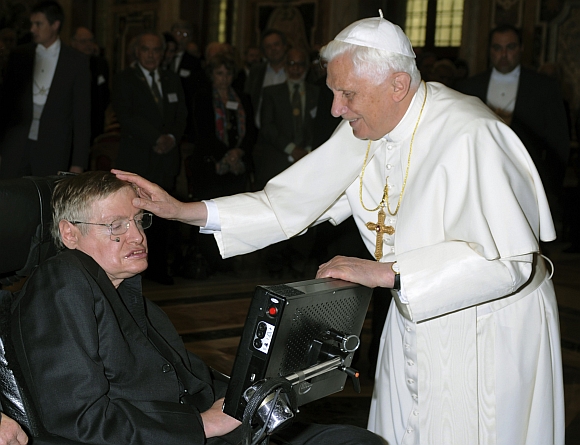 Pope Benedict XVI greets British professor Stephen Hawking during a meeting of science academics at the Vatican