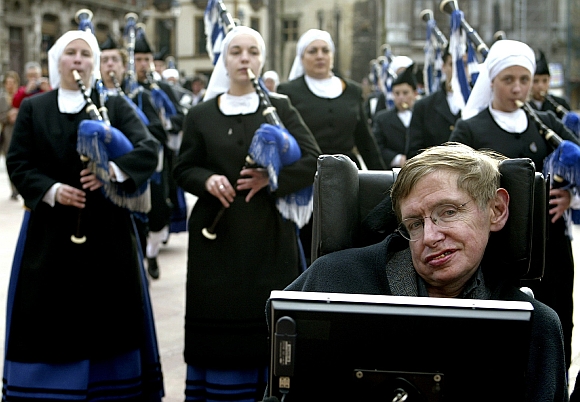 Hawking is surrounded by pipers as he arrives at Oviedo's cathedral in Spain