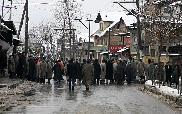 Youths block a road in Srinagar as they protest against the frequent power cuts in the Valley