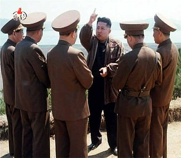 New leader of North Korea Kim Jong-un speaks while surrounded by soldiers in this undated still image taken from video