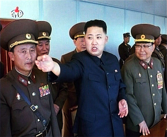 New leader of North Korea Kim Jong-un speaks while surrounded by soldiers in this undated still image
