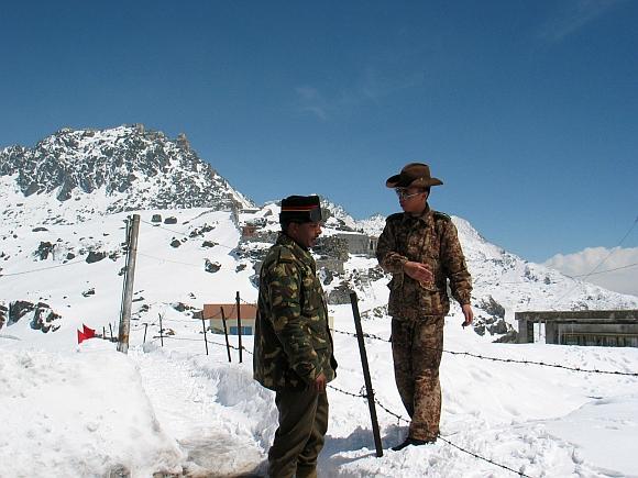 An Indian Army officer with a Chinese soldier at the 4,310 metre high Nathu-la pass on the country's northeastern border with China