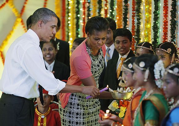 US President Barack Obama and first lady Michelle Obama light Diwali candles at Holy Name High School in Mumbai