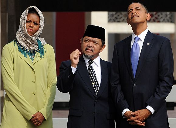 Barack and Michelle Obama are led on a tour by Grand Imam Ali Mustafa Yaqub at the Istiqlal Mosque in Jakarta