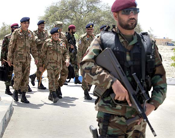 A security personnel keeps guard while Pakistani Army Chief Ashfaq Parvez Kayani arrives to inaugurate a technical training center in Gwadar in Balochistan Province