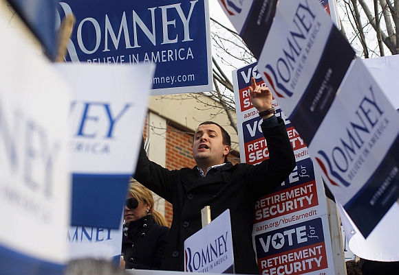 A supporter of Romney chants outside a polling station in Manchester