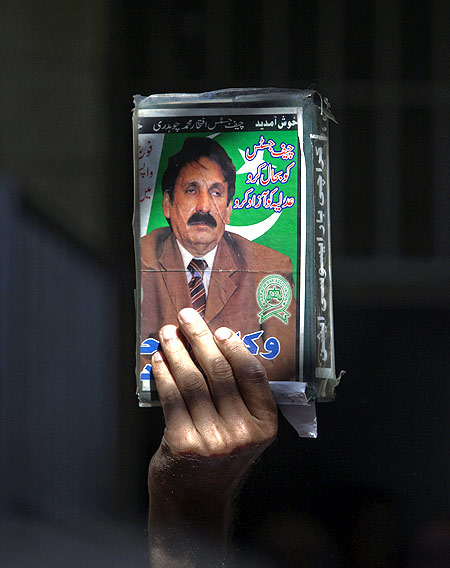 A lawyer holds an image of Chief Justice Iftikhar Chaudhry