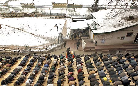 Muslims offer prayers on a snow-laden day in Srinagar