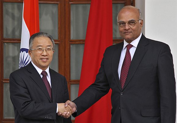 Dai Bingguo, China's state councillor, shakes hands with NSA Menon in New Delhi on Monday