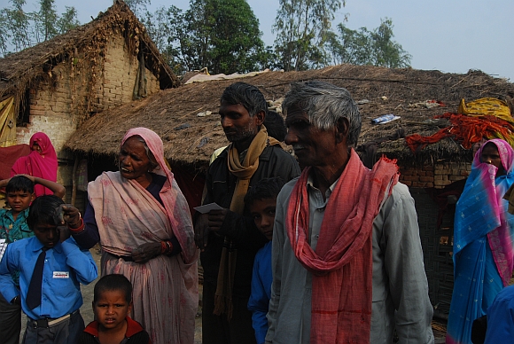 Suresh Kumar, centre, with his parents. He alleges his land was usurped by Yadavs from the neighbouring village