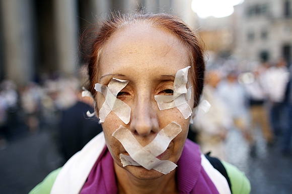A woman taped her eyes and mouth to protest against a privacy law