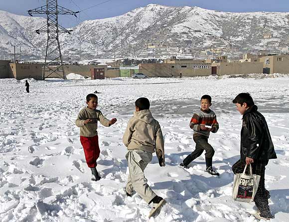 Afghan children play in the snow in an old part of Kabul.