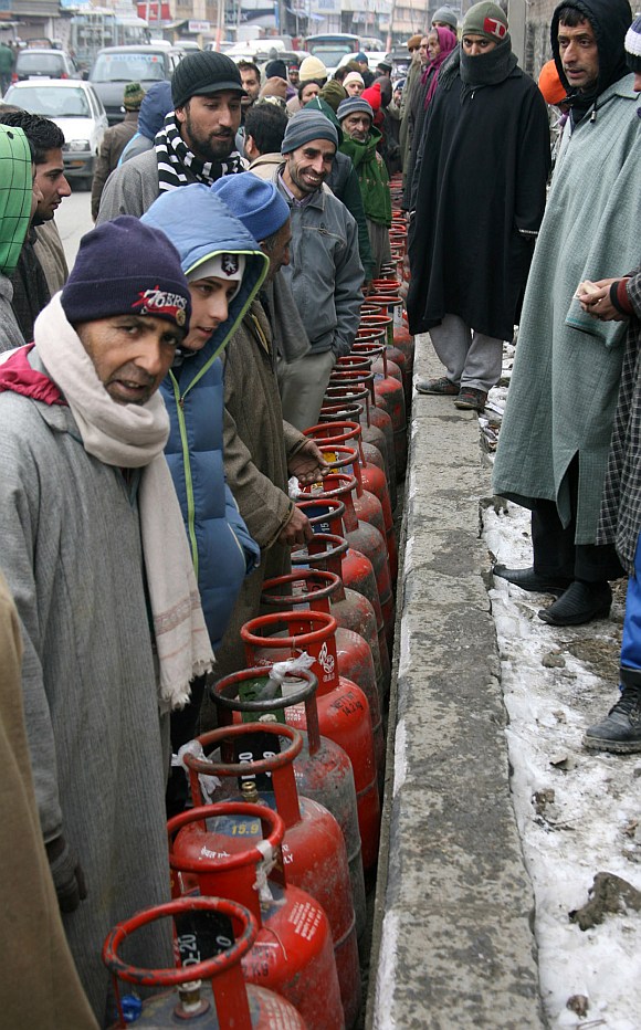 People wait in long queues to collect LPG cylinders