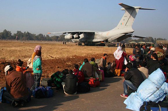 Stranded passengers waiting to aboard a special aircraft of the IAF at the airport in Jammu, on Saturday